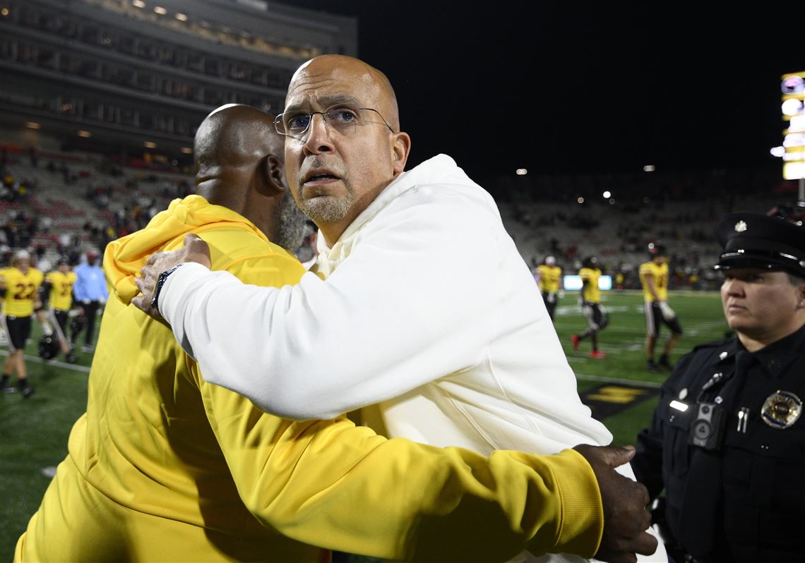 Penn State head coach James Franklin, front right, meets with Maryland head coach Mike Locksley, left, after an NCAA college football game, Saturday, Nov. 4, 2023, in College Park, Md. 