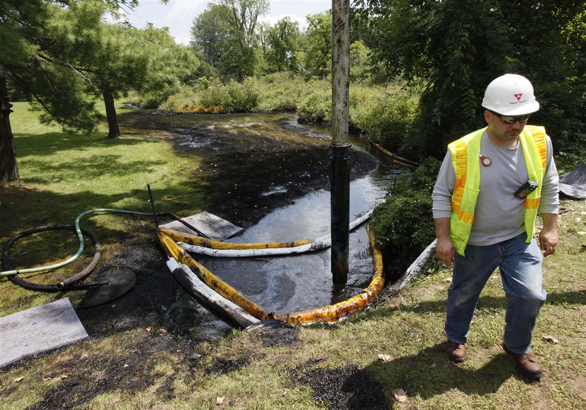 FILE - In this July 29, 2010 file photo, a worker monitors the water in Talmadge Creek in Marshall Township, Mich., near the Kalamazoo River as oil from a ruptured pipeline, owned by Enbridge Inc, is vacuumed out the water. The U.S. Department of Transportation wants to expand rules for pipelines carrying oil, gasoline and other hazardous liquids inspections requirements to include rural areas that are currently exempt, and for companies to more closely analyze the results of their inspections. (AP Photo/Paul Sancya, File)
