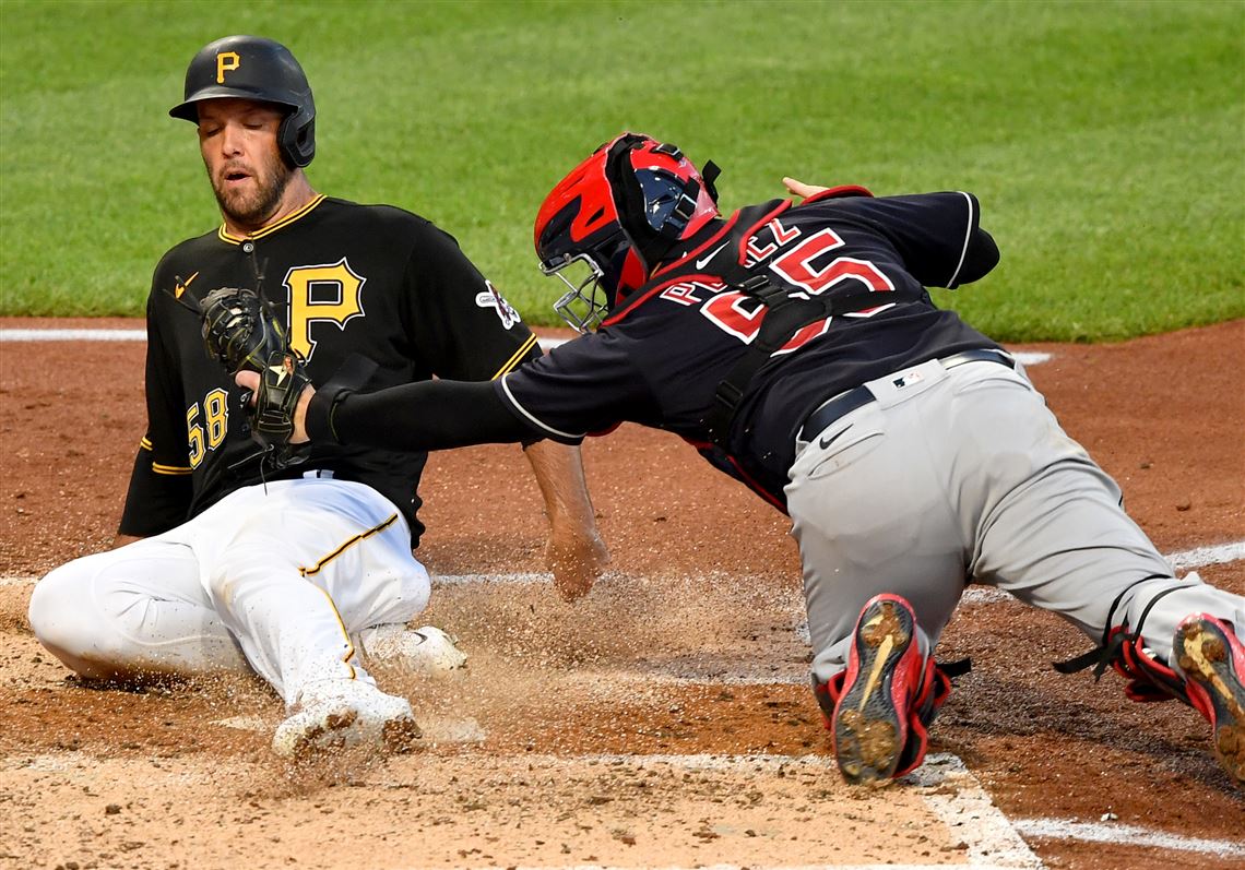 A Pittsburgh Pirates sits in the empty seats of PNC Park and watches an  exhibition game against the Cleveland Indians on Saturday, July 18, 2020 at PNC  Park in Pittsburgh. Photo by