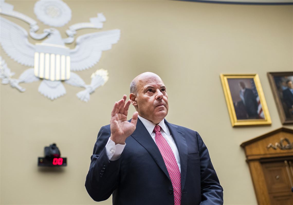 Postmaster General Louis DeJoy is sworn in before testifying during a House Oversight and Reform Committee hearing on the U.S. Postal Service on Aug. 24 on Capitol Hill in Washington. The Postal Service agreed Wednesday to reverse changes that slowed mail service nationwide.