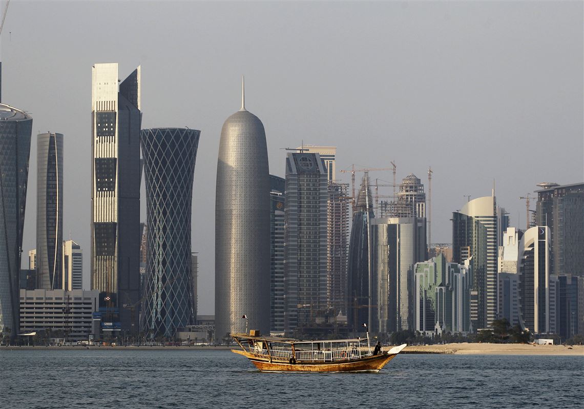 FILE - In this Thursday Jan. 6, 2011 file photo, a traditional dhow floats in the Corniche Bay of Doha, Qatar, with tall buildings of the financial district in the background. Qatar likely faces a deadline this weekend to comply with a list of demands issued to it by Arab nations that have cut diplomatic ties to the energy-rich country, though its leaders already have dismissed the ultimatum. (AP Photo/Saurabh Das, File)