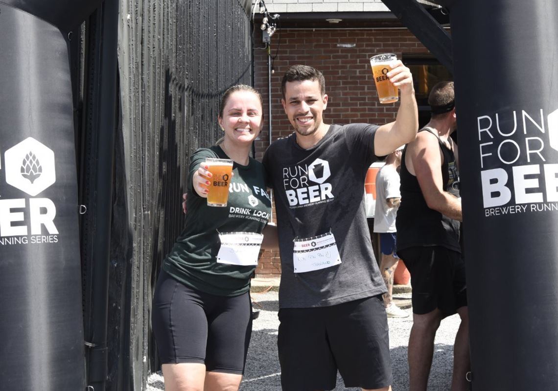 Runners enjoy a pint at Strange Roots Experimental Ales in Millvale after finishing a PA Brewery Running Series 5K fun run. 