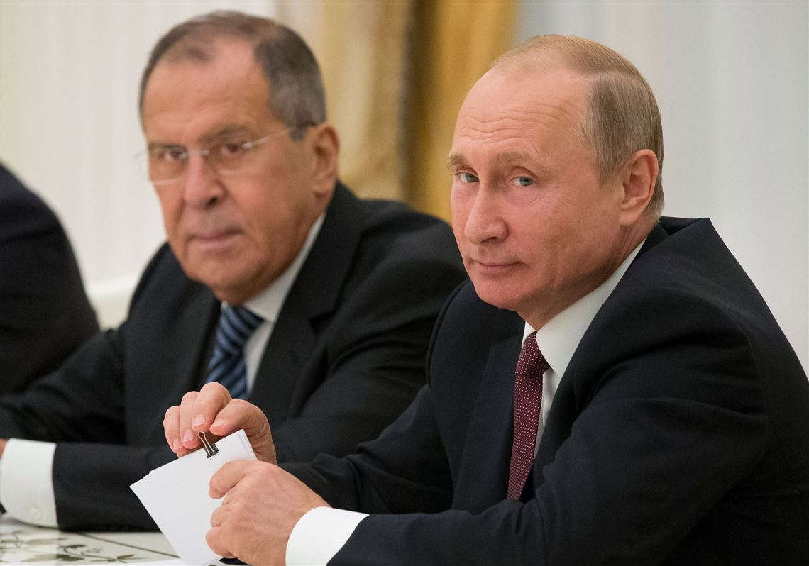 Russian President Vladimir Putin, right, and Russian Foreign Minister Sergey Lavrov attend talks with the U.S. national security adviser at the Kremlin in Moscow on June 27, 2018.