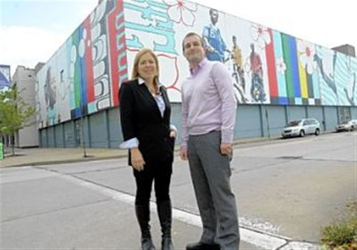 Sprout Fund founders Cathy Lewis Long and Matt Hannigan stand in front of the East Liberty mural 