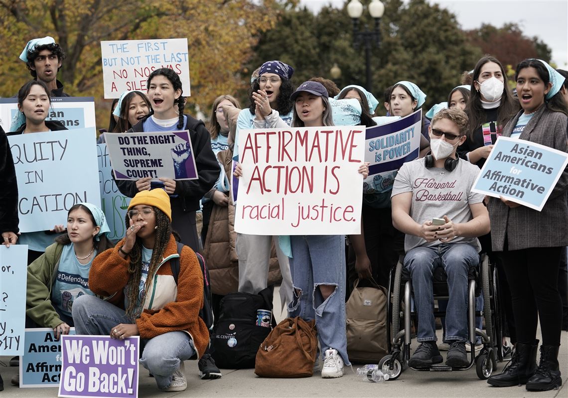 People rally outside the Supreme Court as the court hears oral arguments in two affirmative action cases.