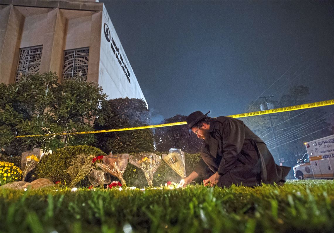 Rabbi Eli Wilansky lights a candle after a mass shooting at Tree of Life synagogue on Oct. 27 in Squirrel Hill. Eleven people were killed and six were wounded, including four police officers.