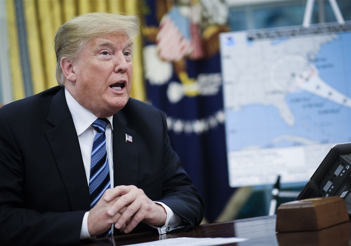 President Donald Trump speaks to reporters on the status of Hurricane Florence and preparations for its landfall, in the Oval Office of the White House, Sept. 11, 2018.  