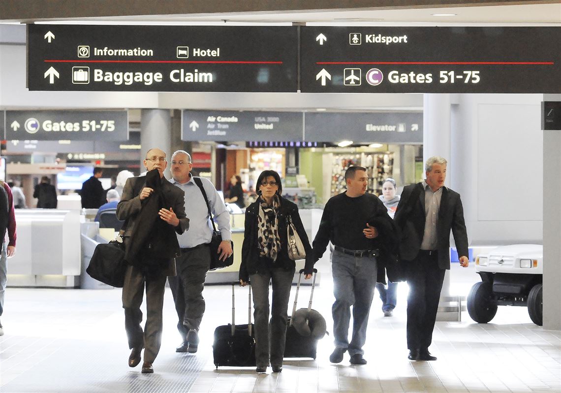 Travelers head to their terminal at the Pittsburgh International Airport. Costs per passenger are increasing for airlines.