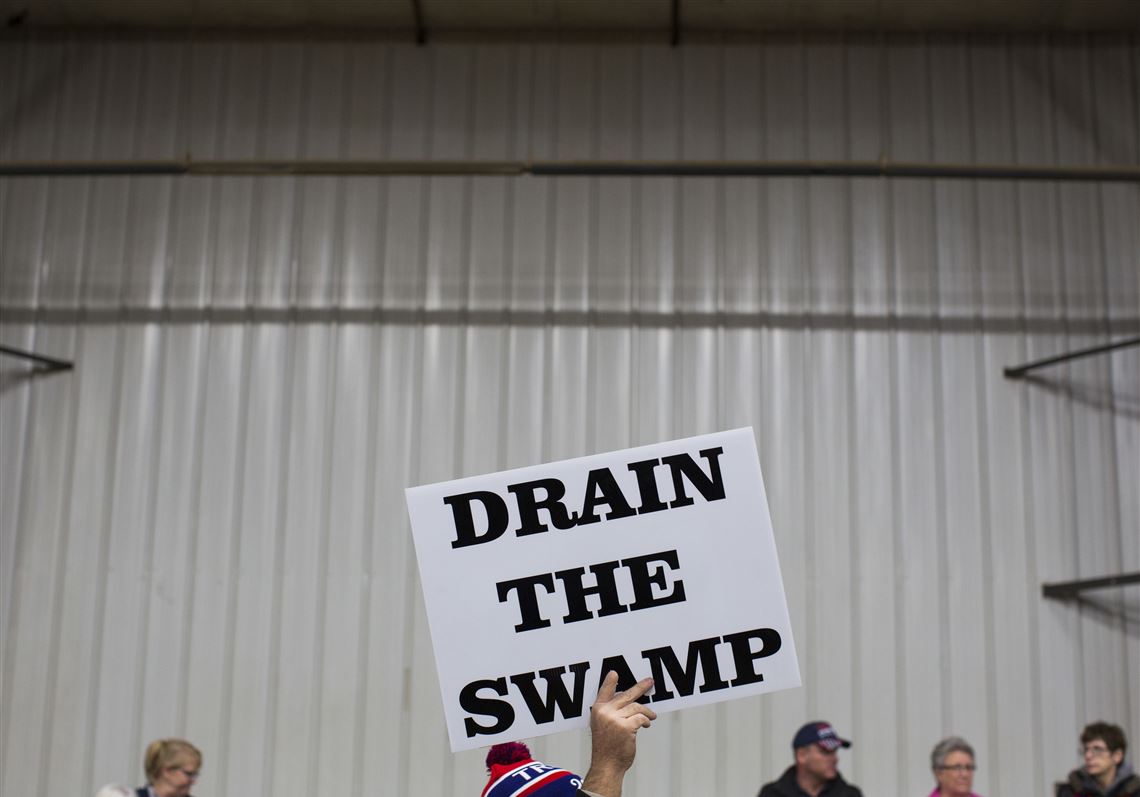 FILE - In this Oct. 27, 2016, file photo, supporters of then-Republican presidential candidate Donald Trump hold signs during a campaign rally in Springfield, Ohio. Despite President Donald Trumpâ€™s campaign to â€œdrain the swampâ€ of lobbyists and special interests, Washingtonâ€™s influence industry is alive and well _ and growing. Former members of the Trump transition team, presidential campaign, administration and friends have set up shop as lobbyists and cashed in on connections, according to a new analysis by Public Citizen, a public interest group, and reviewed by The Associated Press.  (AP Photo/ Evan Vucci, file)
