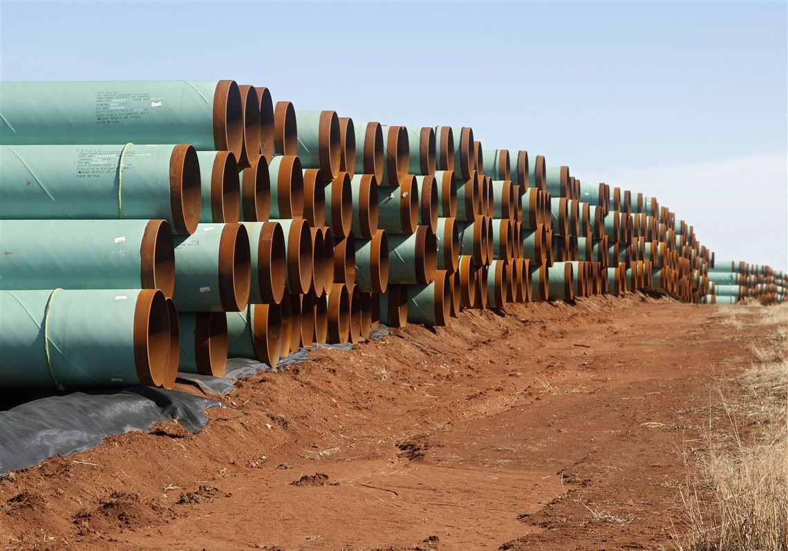 FILE - In this Feb. 1, 2012 file photo, miles of pipe ready to become part of the Keystone Pipeline are stacked in a field near Ripley, Okla. It was a nice story while it lasted. Moments from signing orders to advance the stalled Keystone XL and Dakota Access pipelines, President Donald Trump comes up with the idea of making the projects use pipes and steel made in the U.S. He inserts a â€œlittle clauseâ€ to that effect and vows the projects will only happen if his buy-American mandate is met.  (AP Photo/Sue Ogrocki, File)