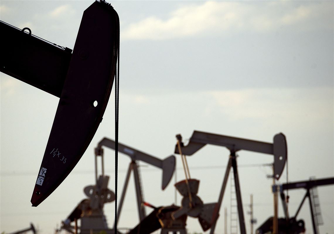 Pump­jacks work in a field near Lov­ing­ton, N.M. 