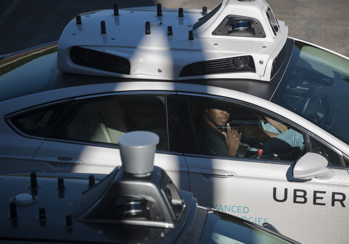 Uber Ford Fusions in the parking lot of Uber's new Advanced Technical Center in Pittsburgh on Sept. 12, 2016.