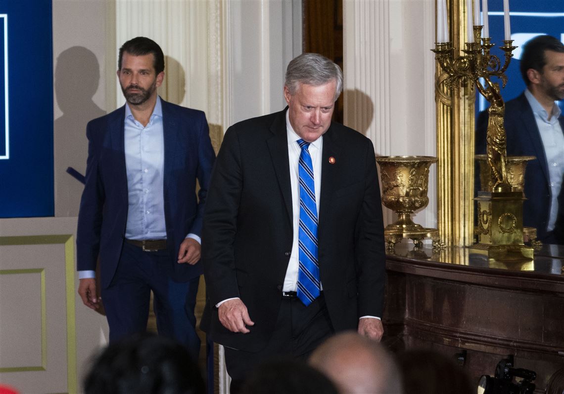 White House Chief of Staff Mark Meadows, center, and Donald Trump Jr. arrive ahead of President Donald Trump on Wednesday in the the East Room of the White House in Washington.