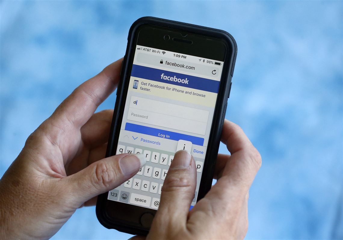 In this Aug. 21, 2018, file photo, a Facebook start page is shown on a smartphone in Surfside, Fla.