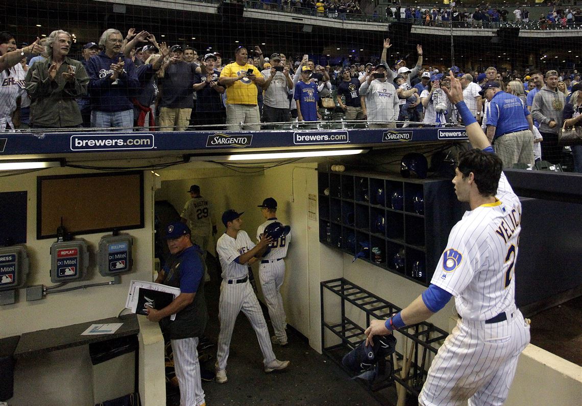 In this Sept. 7 photo, fans cheer as Milwaukee Brewers outfielder Christian Yelich walks off the field after driving in the winning run with a double during the ninth inning of the team's  game against the Chicago Cubs in Milwaukee. Baseball Commissioner Rob Manfred and union head Tony Clark reached what MLB understood to be a framework to start the pandemic-delayed season on July 19 or July 20, but the union did not immediately embrace it as a deal