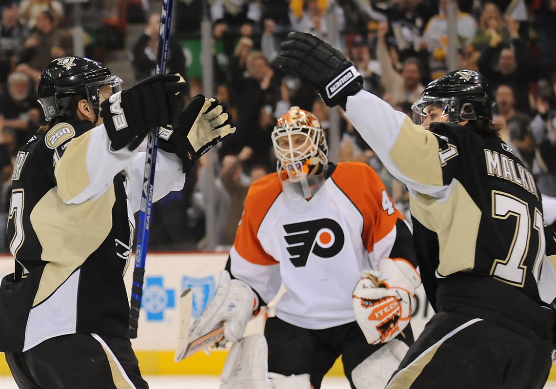 The puck goes past the glove of Philadelphia Flyers goalie Martin