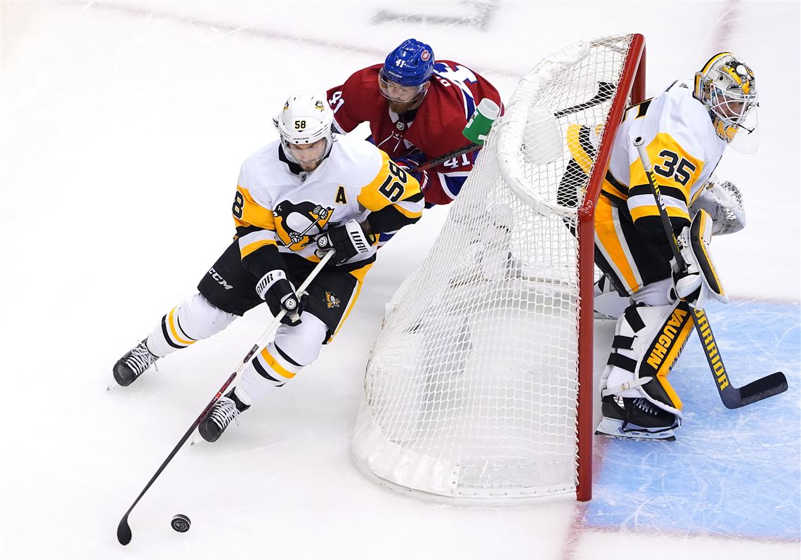 Pittsburgh Penguins' Sidney Crosby, left, can't get a wrap-around