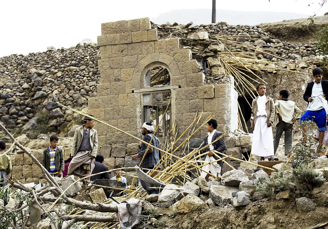 Yemenis gather as they search for survivors Saturday in the rubble of houses destroyed by Saudi-led airstrikes in a village near Sanaa, Yemen.