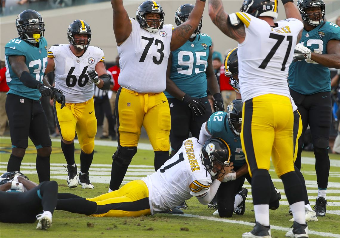 Photo: Jacksonville Jaguars fans celebrate a 45-42 win over the