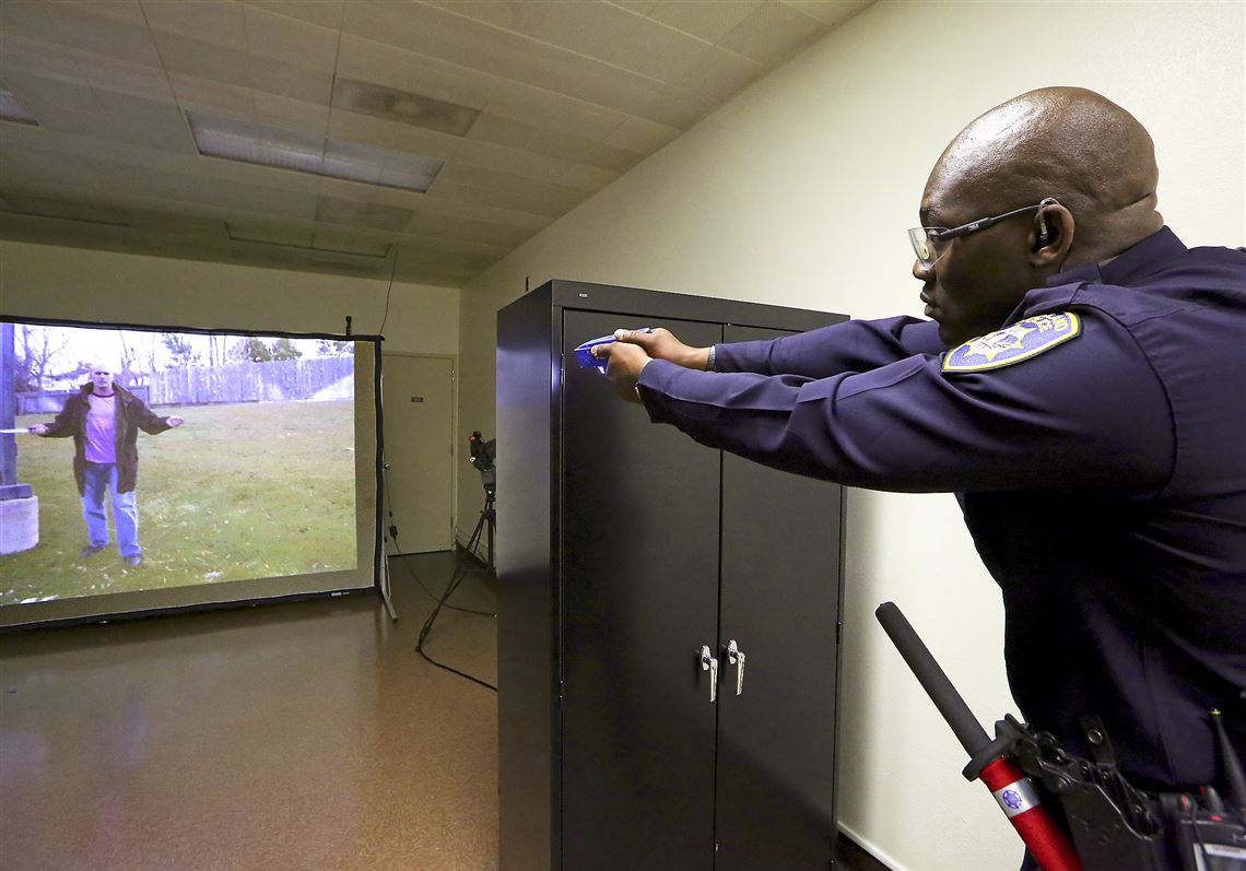 Lt. Sekou Millington of the Oakland, Calif., police department uses his Taser to respond to a video scenario where a woman stepped away from a man who was holding a large knife.