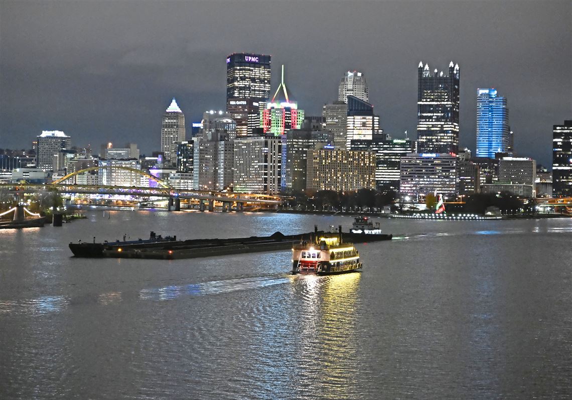A barge and Gateway Clipper boat navigate the Ohio River during Light Up Night on Saturday, Nov. 23, 2024. The Monongahela, Allegheny, and Ohio rivers are inextricably linked to Pittsburgh’s identity and the region’s economy. 