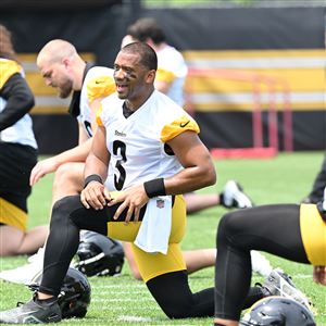 Steelers quarterback Russell Wilson, stretches with the offense during OTA practice at the UPMC Rooney Sports Complex on the South Side Tuesday, May 21, 2024.