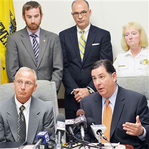 Pittsburgh Mayor Bill Peduto, right, and acting Public Safety Director Stephen Bucar, left, speak during today's press conference. In the background are Pittsburgh City Council members Dan Gilman, left, and Bruce Kraus, center, and acting Police Chief Regina McDonald.