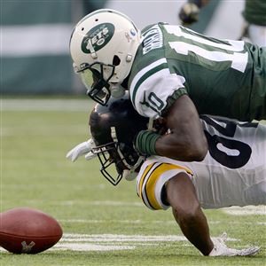 Pittsburgh Steelers Jason Worilds runs with New York Jets Michael Vick who  scrambles out of the pocket in the first half in week 10 of the NFL season  at MetLife Stadium in