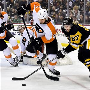 The Penguins' Sidney Crosby battles for loose puck against the Flyers Nicklas Grossmann in the first period of Wednesday night's 4-1 loss to Philadelphia at the Consol Energy Center.
