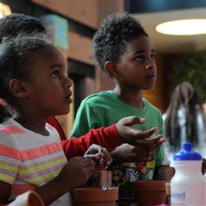 Children decorate pots at a celebration for Homewood Children's Village held in 2015. The organization is one of 66 in the region that will receive funding for in-person summer camps and activities this year.