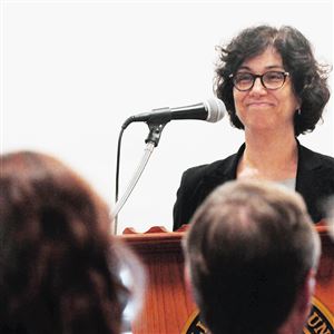 Karen Hacker, director of the Allegheny County health department, smiles Tuesday as she presents the Plan for a Healthier Allegheny during a news conference.