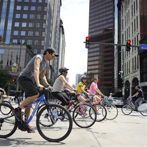 Bicyclists cross Liberty Avenue, Downtown, as part of the Open Streets Pittsburgh event on May 31.