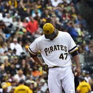 Pittsburgh Pirates second baseman Neil Walker throws on to first to  complete a double play as Milwaukee Brewers' Aramis Ramirez slides to  second in the second inning of the baseball game on