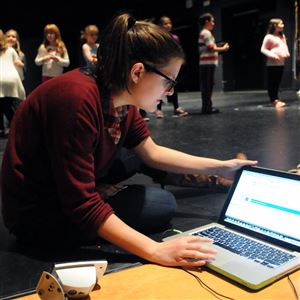Mikayla Davic readies her music during rehearsal of her play 