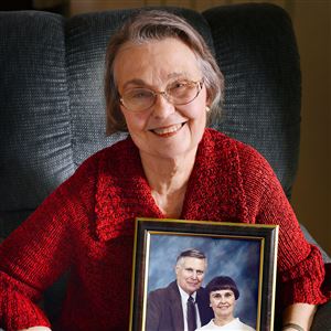 Winnie Slatery, 77, holds a photo of herself with her late husband, Dave. They were married 42 years before he died in 2004.