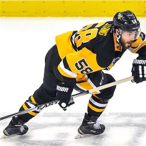 Kris Letang skates up ice against the Sharks.