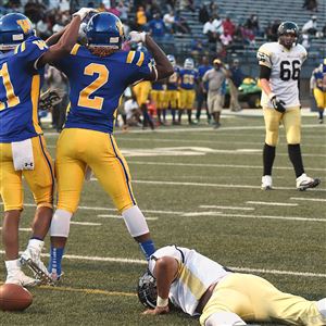 Westinghouse teammates Jeremiah Nash (11) and Genaro Coleman (2) celebrate after Coleman recovered a Brashear fumble in the end zone for a touchdown Thursday night.