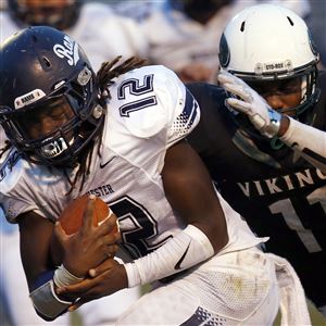 Rochester's Chris Hayes rushes against Sto-Rox's Taiwan Larue last Friday.