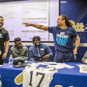 Pitt's Avonte Maddox, second from right, jokes with Jeremiah Taleni, second from left, during the draft for Saturday's Blue-Gold Game.