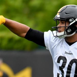 Pittsburgh Steelers running back James Conner (30) shades his eyes as he  watches special team drills