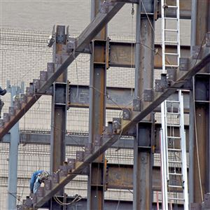 In this Dec. 18, 2017 file photo, an ironworker works on an apartment complex in the Cultural District in Downtown Pittsburgh.