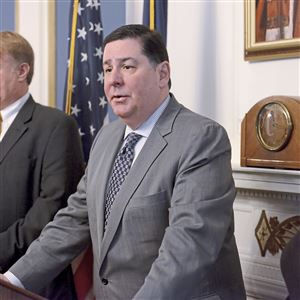 In this January 2018 photo, Mayor Bill Peduto speaks to the media as County Executive Rich Fitzgerald, left, and Allegheny Conference CEO Stefani Pashman listen at the press conference about the Amazon announcement.