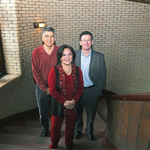Carnegie Mellon University professors Coty Gonzalez, center, David Plaut. left and Christian Lebiere on the stairwell inside Baker Hall on Carnegie Mellon University campus. The researchers have received a DARPA grant to forecast the flow of information online, in conjunction with other researchers from various schools.