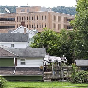 California University of Pennsylvania towers over several houses Tuesday, July 31, 2018, in California, Pa.