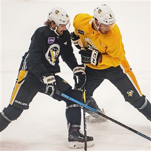 Zach Aston-Reese, left, battles with Jamie Oleksiak during a practice drill.