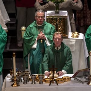 The Rev. Joseph R. McCaffrey leads the first Mass for seven Lawrence County parishes, as priests from those parishes take part, Saturday, Oct. 20, 2018, at New Castle High School in New Castle. 