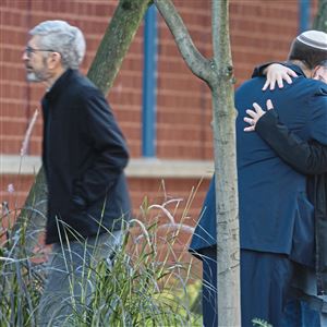 Mourners embrace before the start of the viewing service on Tuesday for Jerry Rabinowitz, one of the victims of the mass shooting on Oct. 27. The service was held at the Jewish Community Center of Greater Pittsburgh on Tuesday, Oct. 30.
