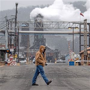 Mike Trumpe of Carroll Township crosses Maple Avenue on Wednesday, Jan. 9, 2019, near U.S. Steel's Clairton Coke Works. The coke-making process produces lots of steam and also emissions comprised of a variety of pollutants, including sulfur dioxide. The American Lung Association’s 20th annual “State of the Air” report, released April 24, 2019, found worsening daily and annual soot pollution in the tri-state metro region for a three-year period, 2015 through 2017, along with higher levels of ground-level ozone, the principal component of unhealthy smog. Allegheny County was the only county outside of California to receive failing grades in both soot categories and ozone.