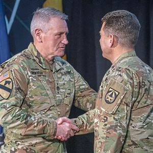 General Mike Murray, Commanding General, Army Futures Command, shakes hands with  Brigadier General Matthew Easley after applying his new patch for the U.S. Army Futures Command during the activation ceremony of U.S. Army Artificial Intelligence Task Force at Carnegie Mellon on Friday, Feb. 1, 2019, in Lawrenceville.  (Andrew Rush/Post-Gazette) 