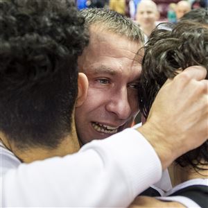 Moon coach Adam Kaufman celebrates with his players after beating Archbishop Wood to win a state championship. 